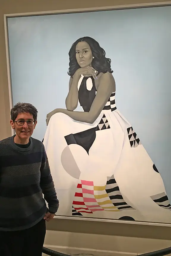 Lynne next to Michelle Obama's portrait